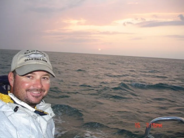Capt. Scott Hughes on the water at sunset
