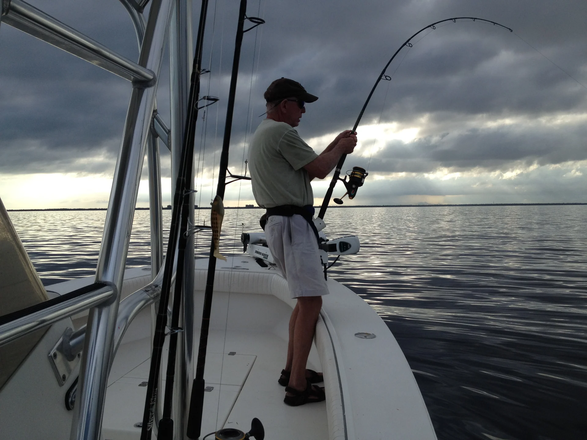 An angler fighting a tarpon at sunrise