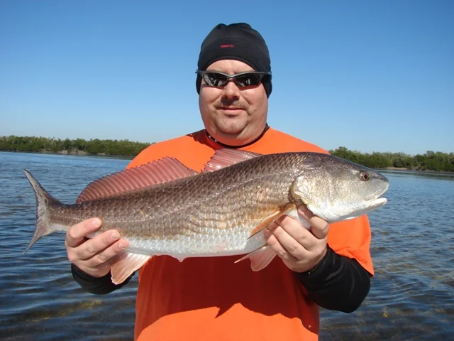 A guest holding a redfish