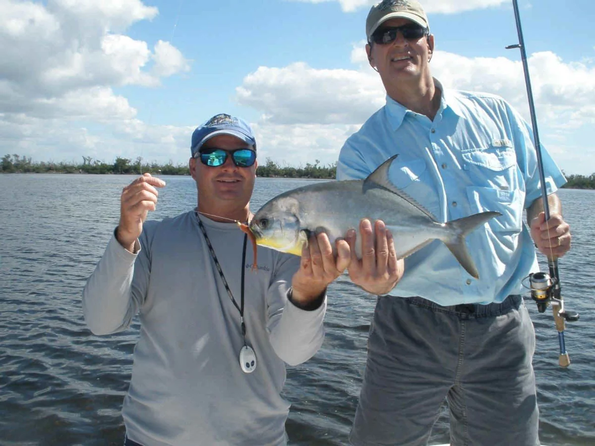 A guest holding pompano