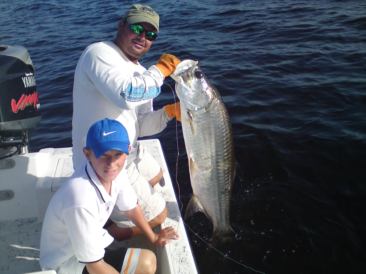 Two anglers with a tarpon